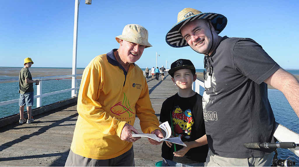 Les Ryan will miss being able to share his knowledge and passion with recreational anglers in the Fraser Coast after funding was cut to the Fishcare Volunteer program. He is pictured handing out advice to holidaymakers Chris Slater with sons Ben and Matthew on the Urangan Pier. Les Ryan will miss being able to share his knowledge and passion with recreational anglers in the Fraser Coast after funding was cut to the Fishcare Volunteer program. He is pictured handing out advice to holidaymakers Chris Slater with sons Ben and Matthew on the Urangan Pier.